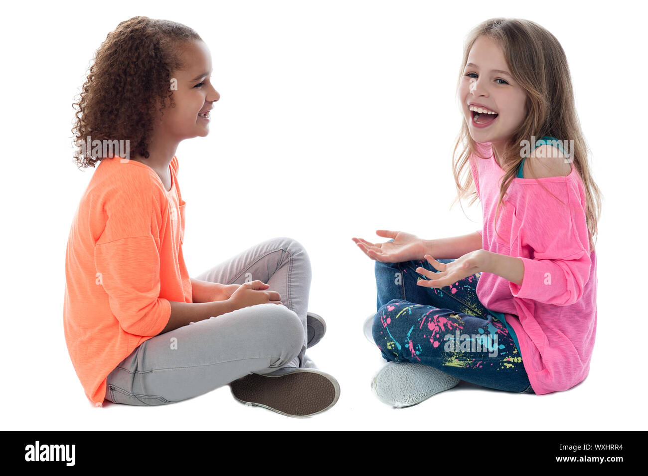 Pretty girls sitting on the floor and playing Stock Photo - Alamy