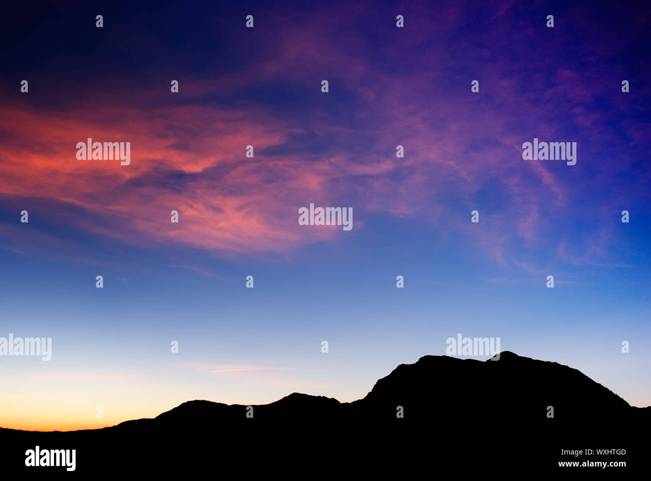 high mountain silhouette with beautiful colorful clouds Stock Photo - Alamy