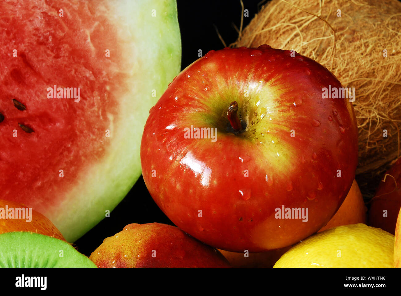 Colorful fresh group of fruits for a balanced diet. Black background ...