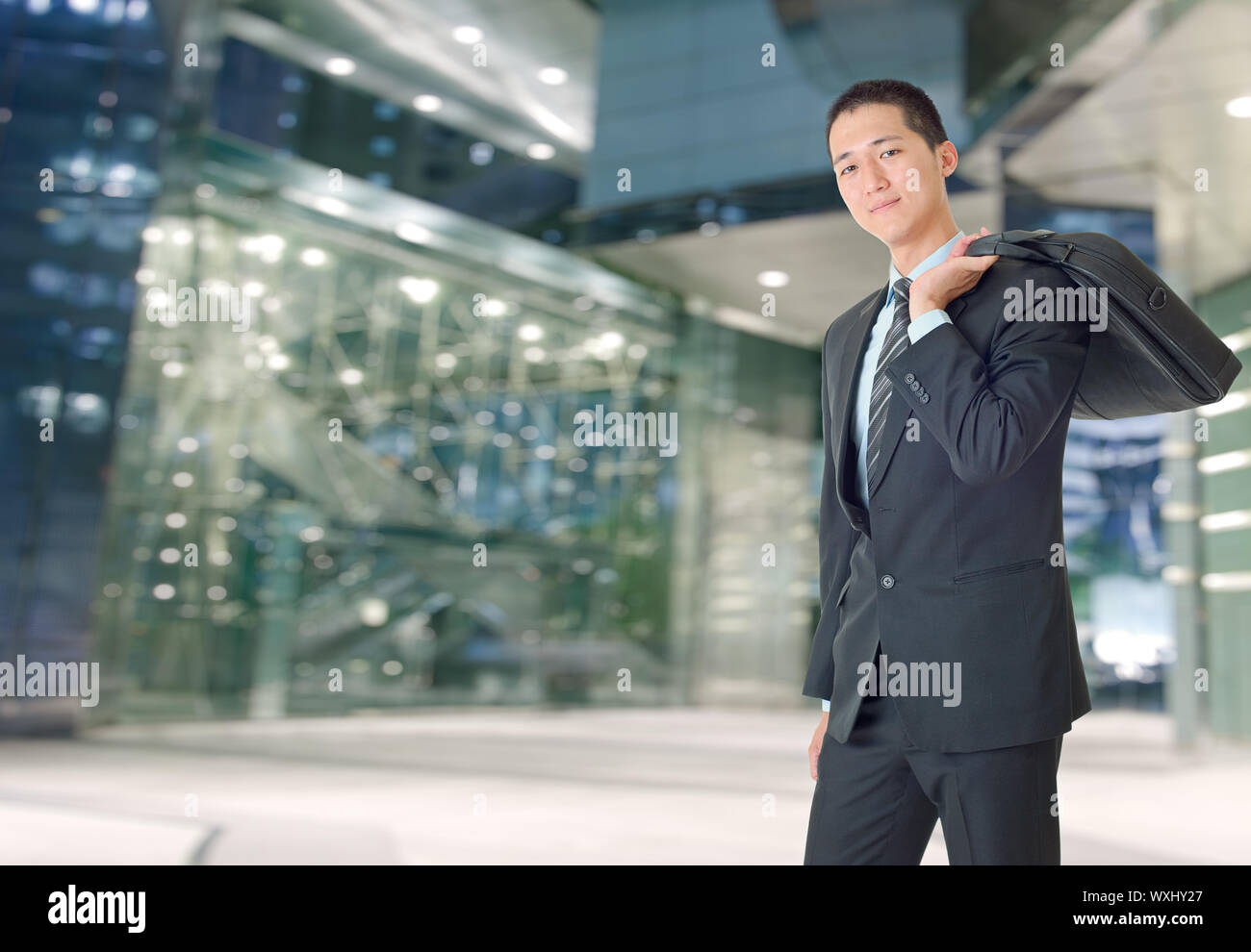 Happy young businessman of Asian outside of office Stock Photo - Alamy