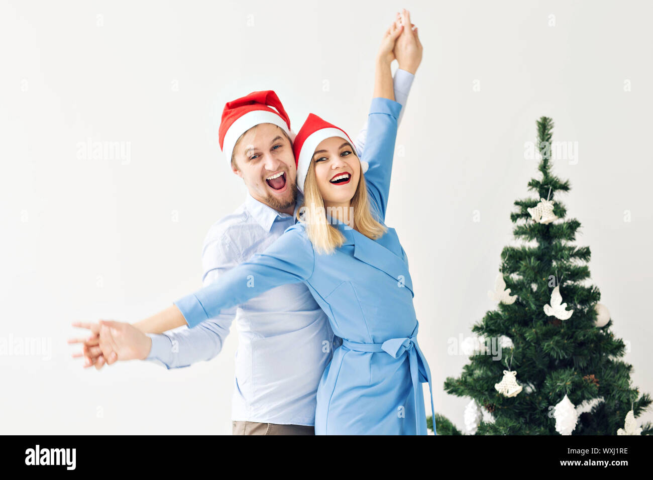 Winter holidays and family concept - Happy young couple near Christmas ...