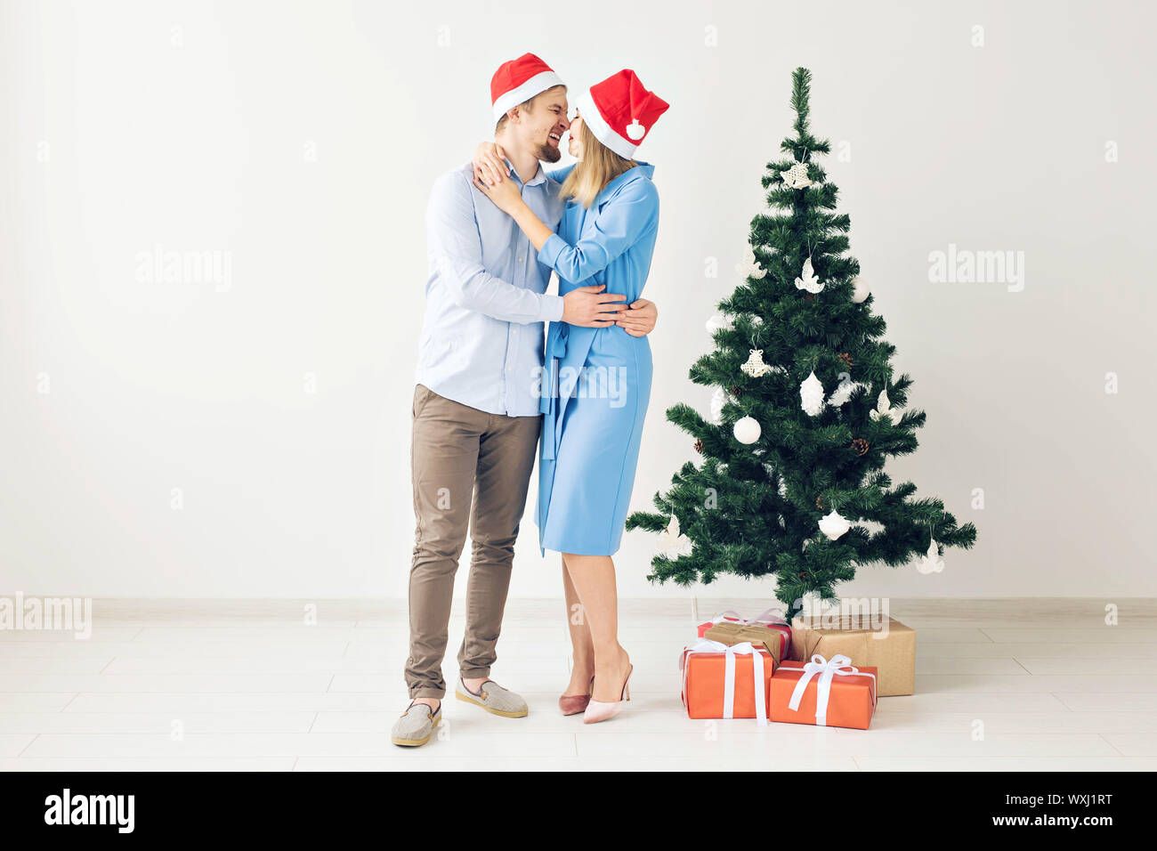 Winter holidays and family concept - Happy young couple near Christmas ...