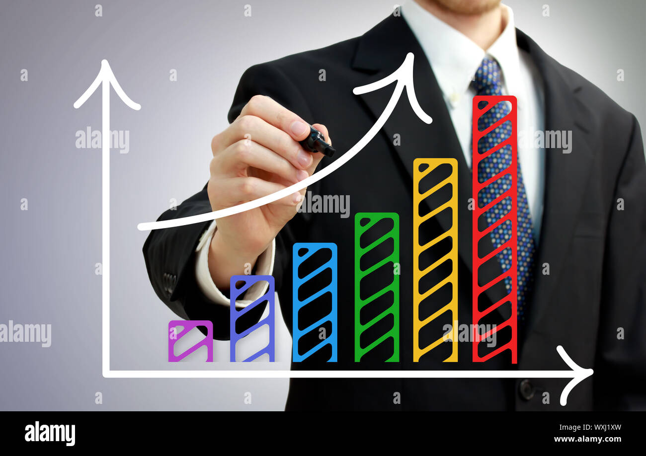 Businessman drawing a rising arrow over a colorful bar graph Stock ...