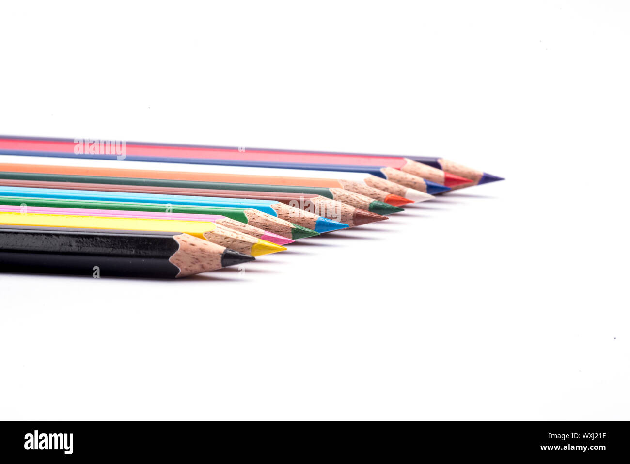Colored pencils arranged on an isolated white background Stock Photo