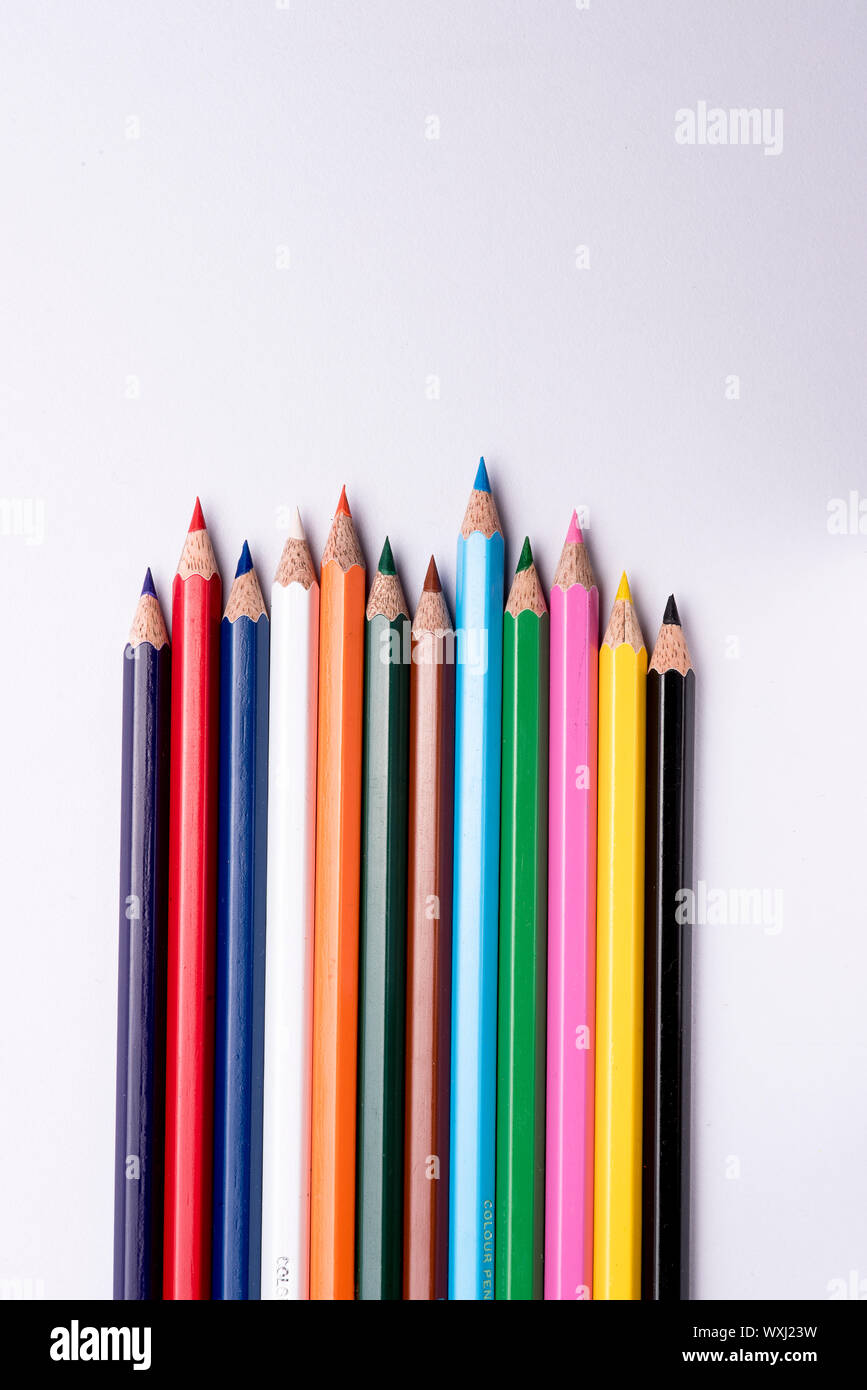 Colored pencils arranged on an isolated white background Stock Photo