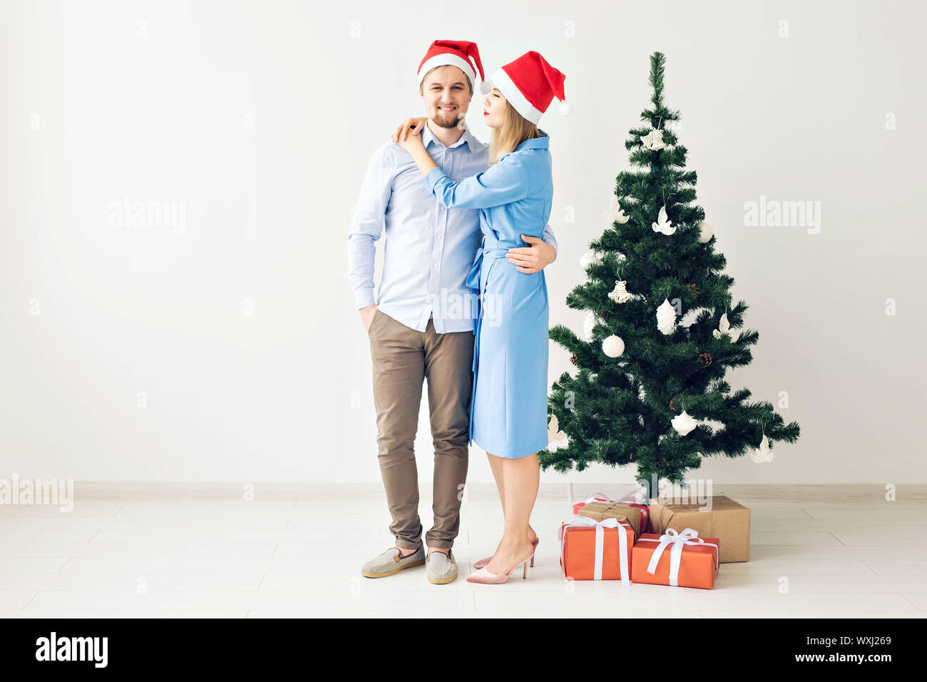 Winter holidays and family concept - Happy young couple near Christmas ...