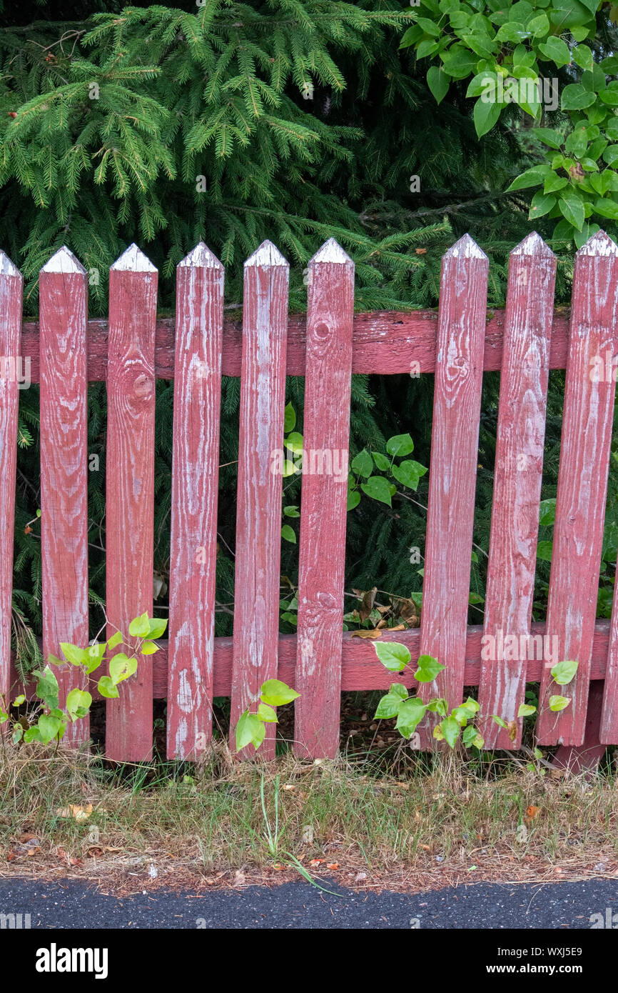 Broken red picket fence Stock Photo