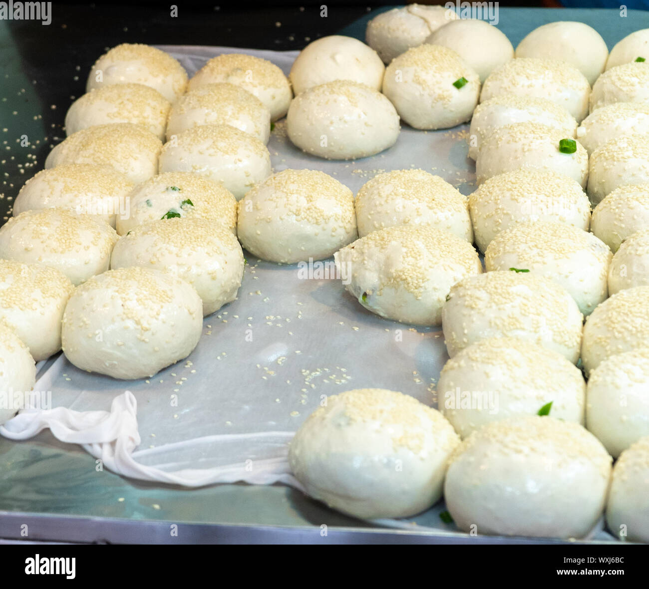 Traditional chinese / taiwanese snack called Hu Jiao Bing or Pepper Pork Buns. Buns filled with Pork backed in a Tandoori Style oven Stock Photo