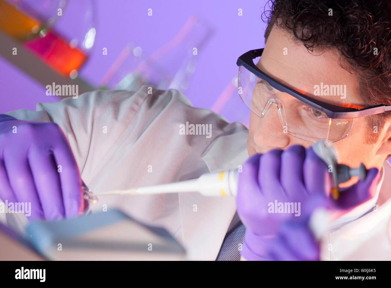 Focused life science professional pipetting master mix solution into