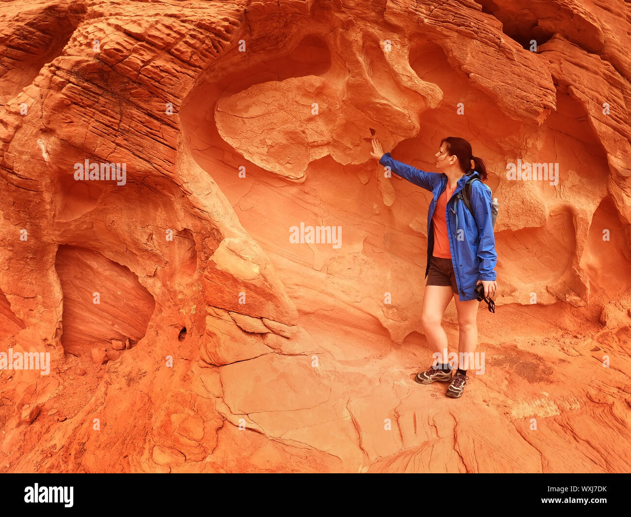 Female hiker touching rocks, Utah, United States Stock Photo