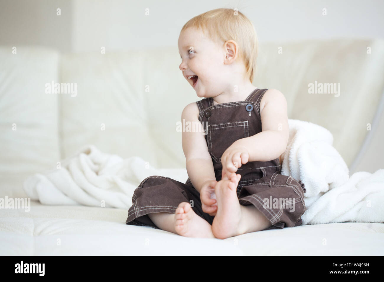 Infant girl sitting on a bed hi-res stock photography and images - Alamy