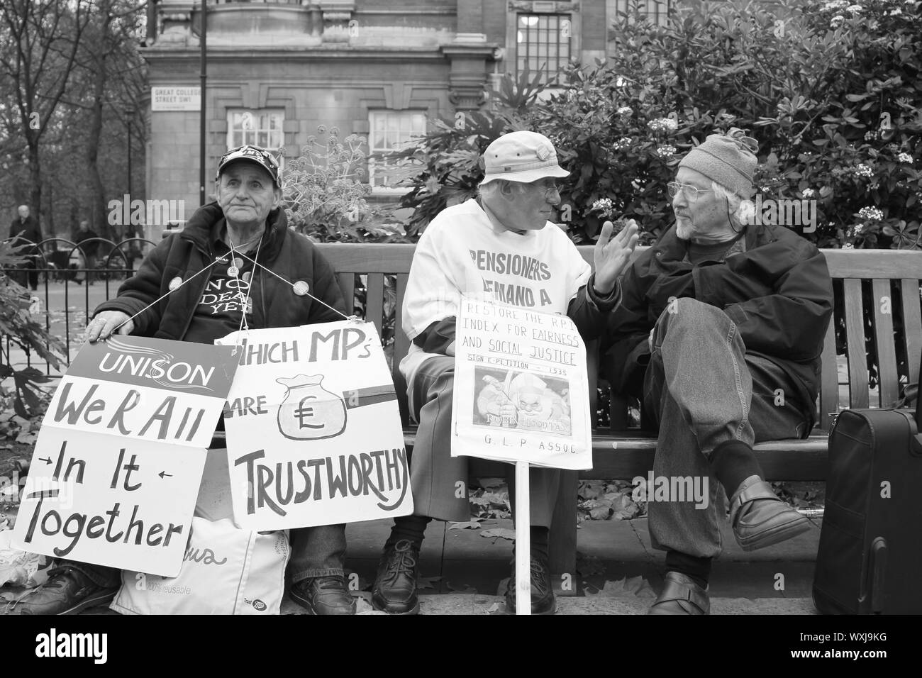 Authentic image of senior citizens at College Green, Westminster holding banners and signs asking for the return of the RPI Index to be restored to bring back fairness to the Government pension pot therefore giving senior citizens a better pension to live on. British pensioner receive one of the lowest payed pensions in the whole of the Western developed World. Stock Photo