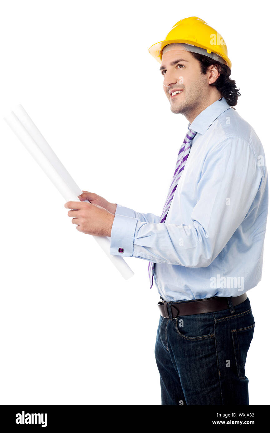 Architect in hard hat holding out construction plan Stock Photo