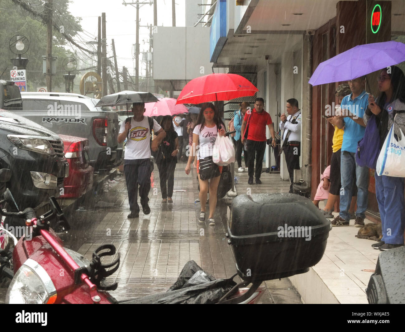 Manila, Philippines. 1st Jan, 2019. Commuters hold umbrellas during the downpour.The southwest monsoon, locally known as habagat, will bring scattered rains over Metro Manila, Zambales, Mimaropa, Calabarzon and West Visayas according to PAGASA Weather Specialist Gener Quitlong. Credit: Josefiel Rivera/SOPA Images/ZUMA Wire/Alamy Live News Stock Photo