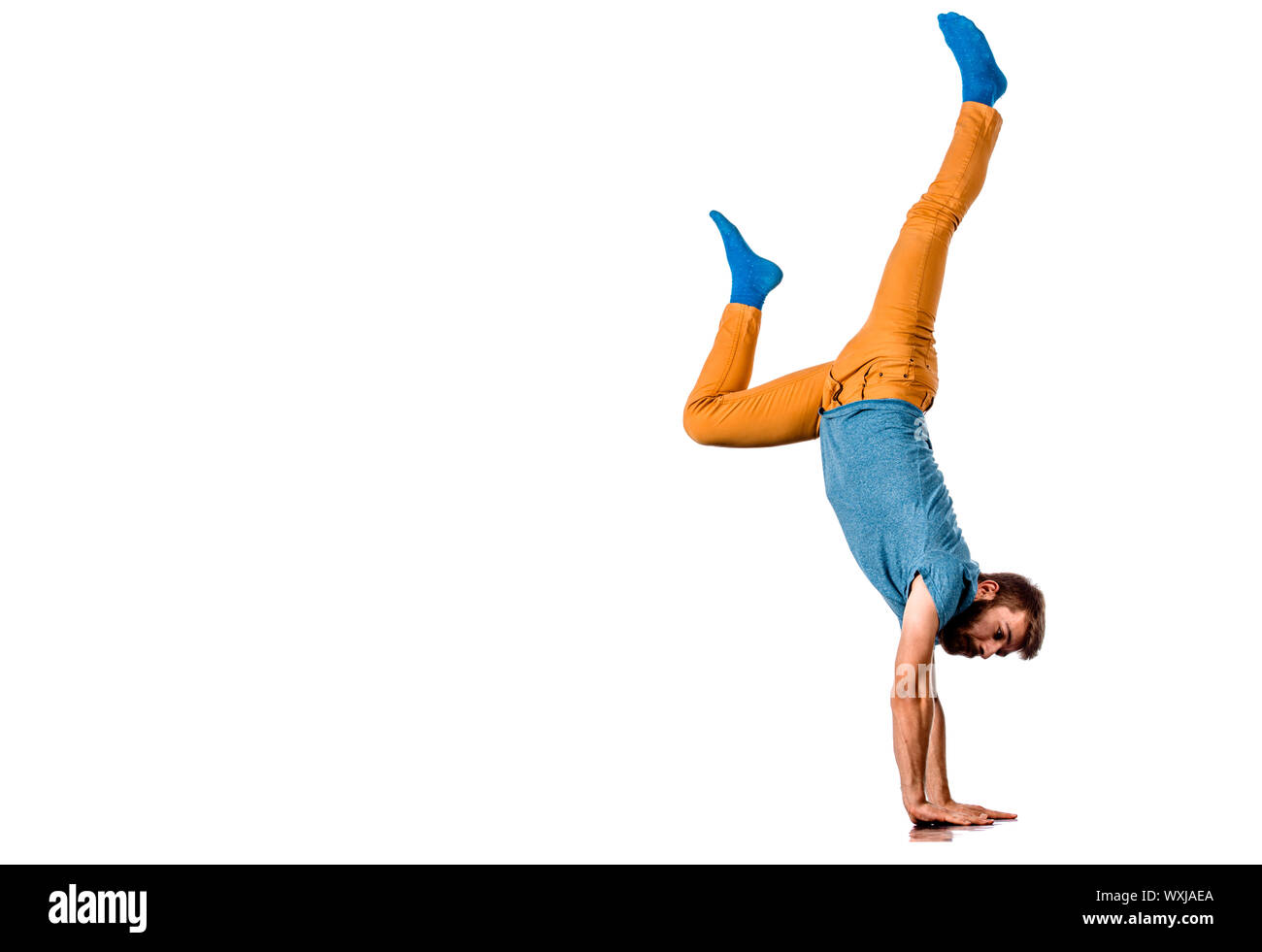 An urban guy is doing breakdance in the studio Stock Photo