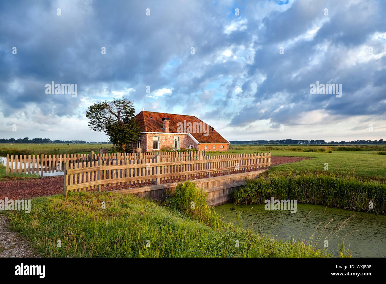 charming farmhouse and beautiful blue sky Stock Photo - Alamy