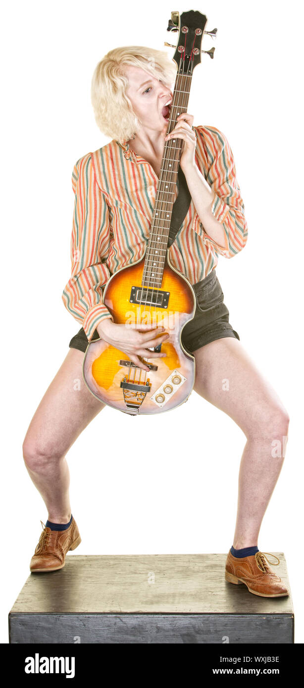 Pretty European blond woman playing guitar with teeth Stock Photo Alamy