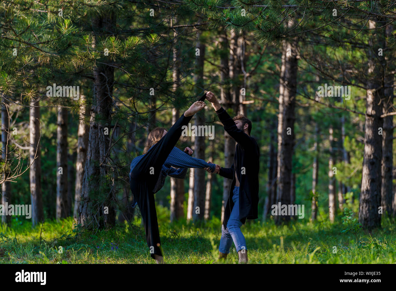 Young beautiful barefoot couple dancer practicing modern dance Stock Photo