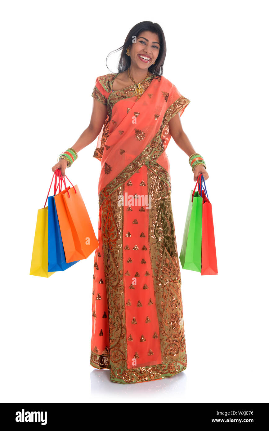 Portrait of full length beautiful traditional Indian woman in sari dress  holding shopping bags, isolated over white background Stock Photo - Alamy