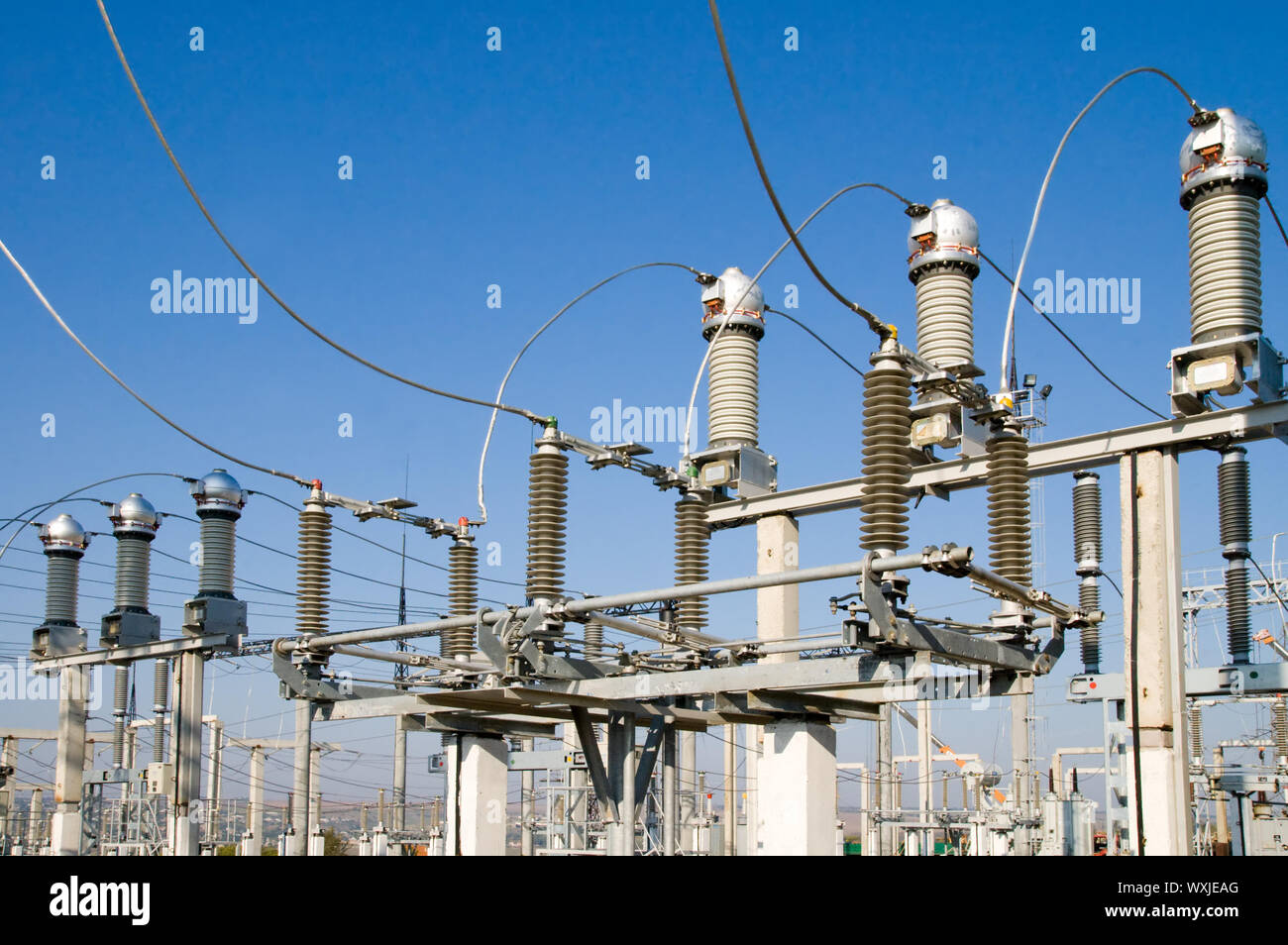 high-voltage substation on blue sky background with switch and disconnector Stock Photo