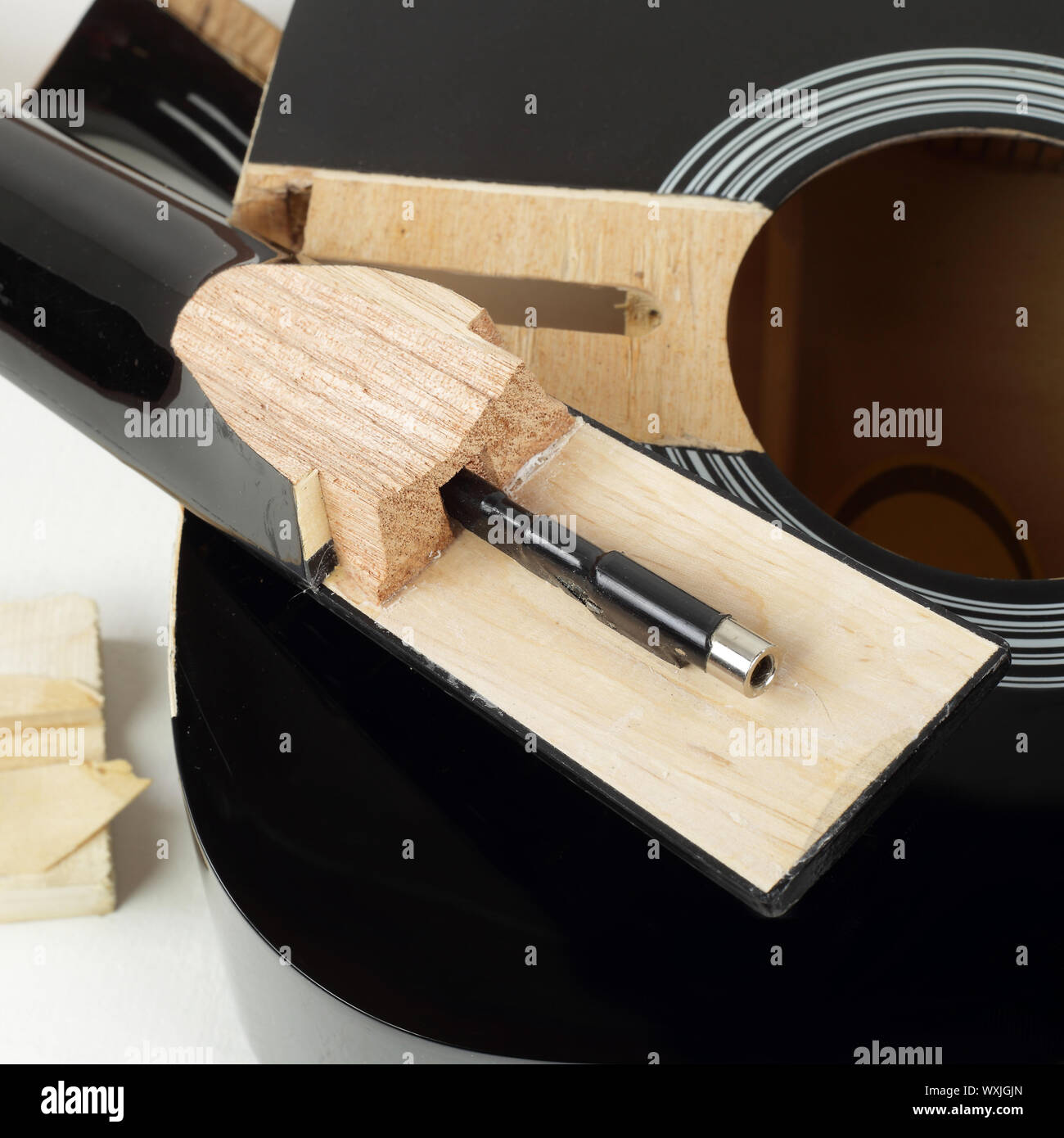 Guitar repair and service Closeup fragment broken sound board and neck acoustic guitar white