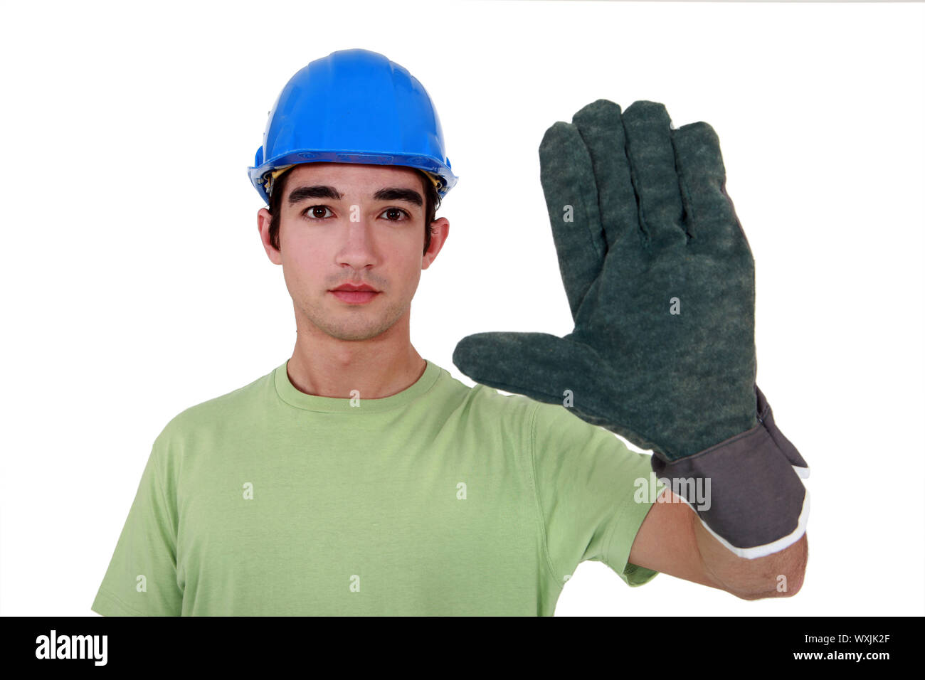 Young tradesman wearing an oversized glove Stock Photo