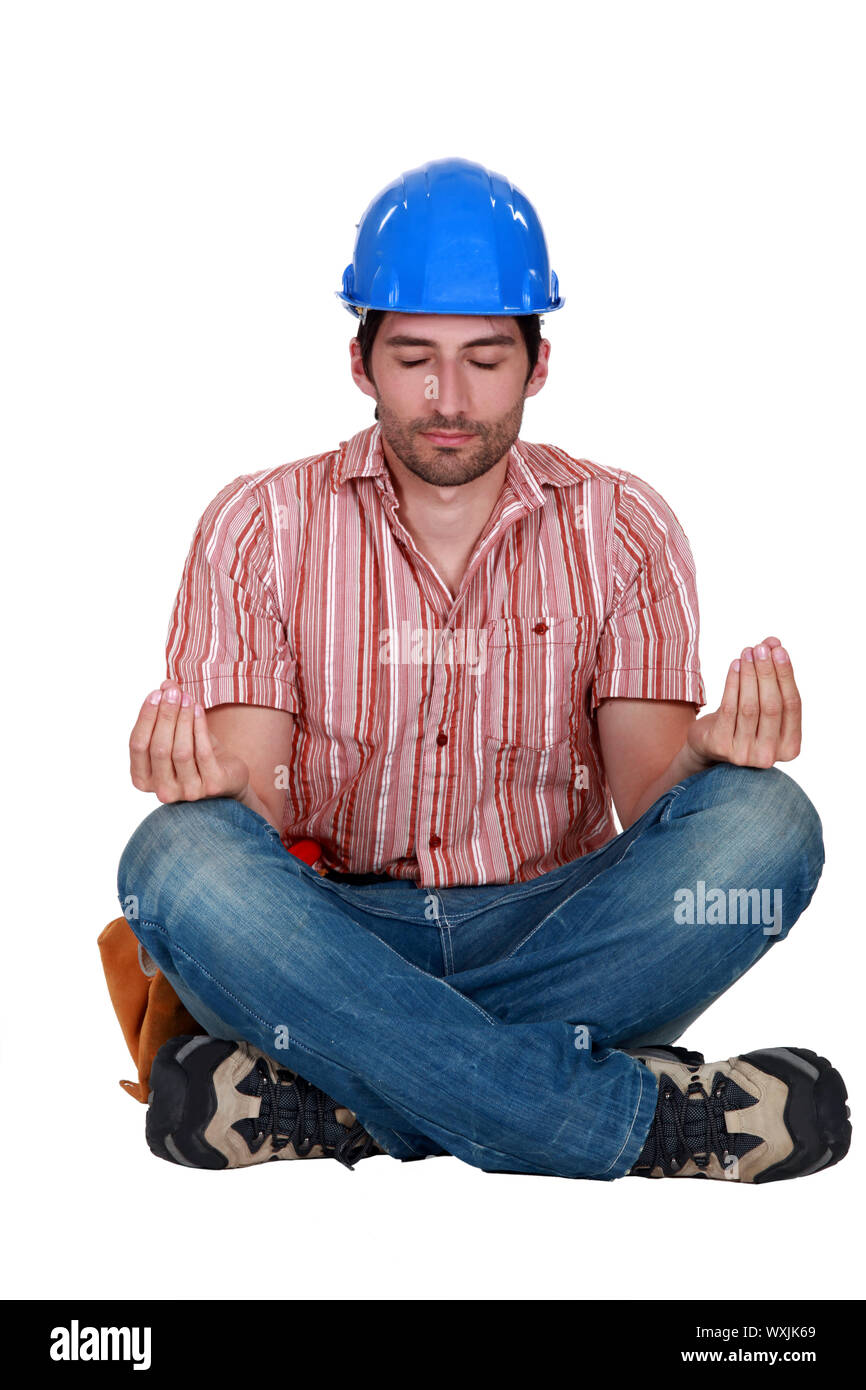 A construction worker in a yoga position Stock Photo Alamy