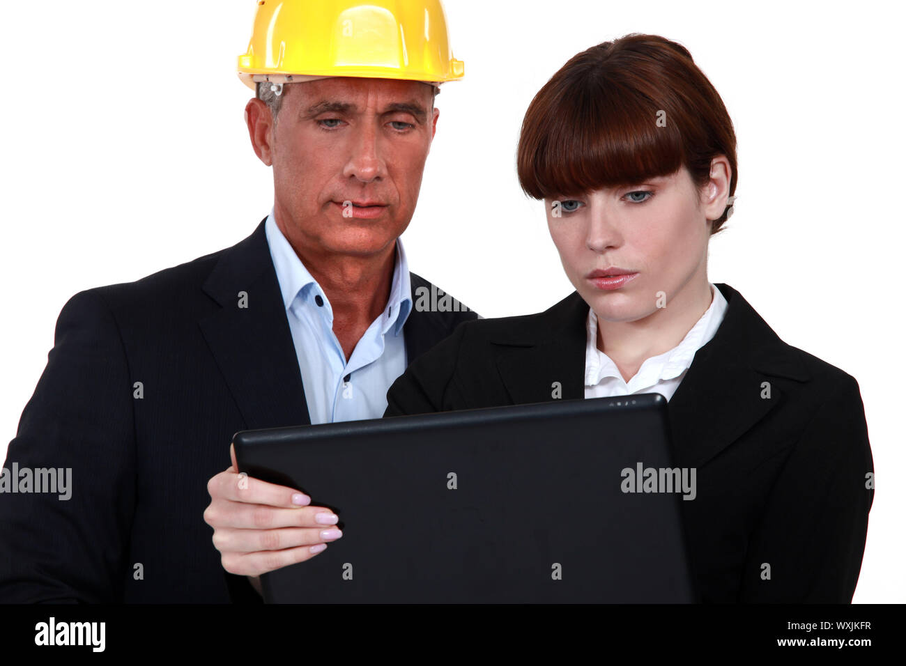Architect showing document to assistant Stock Photo Alamy