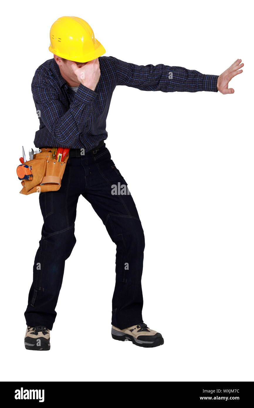 Laborer gesturing on white background Stock Photo