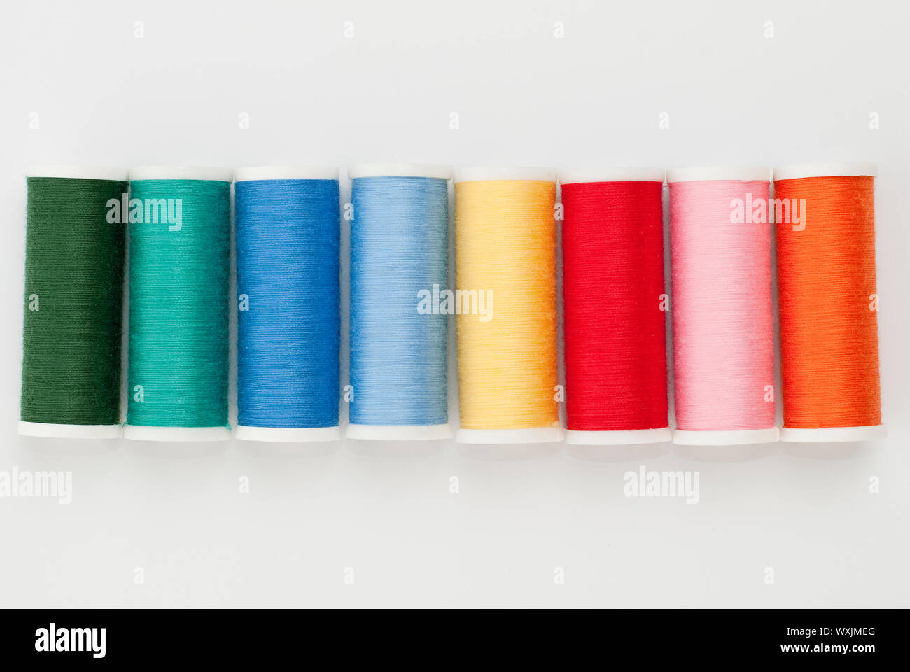 Colorful Spools of sewing thread isolated on white background Stock ...