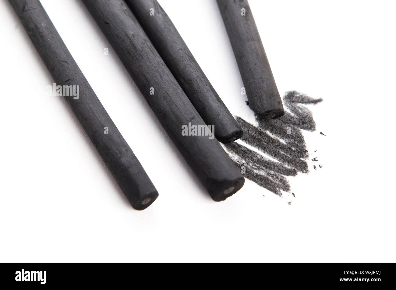 Artist's black charcoal with smudge Stock Photo - Alamy