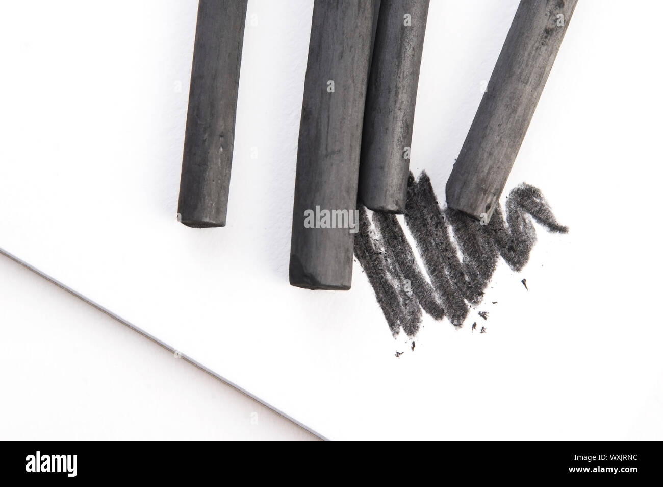 Artist's black charcoal with smudge Stock Photo - Alamy