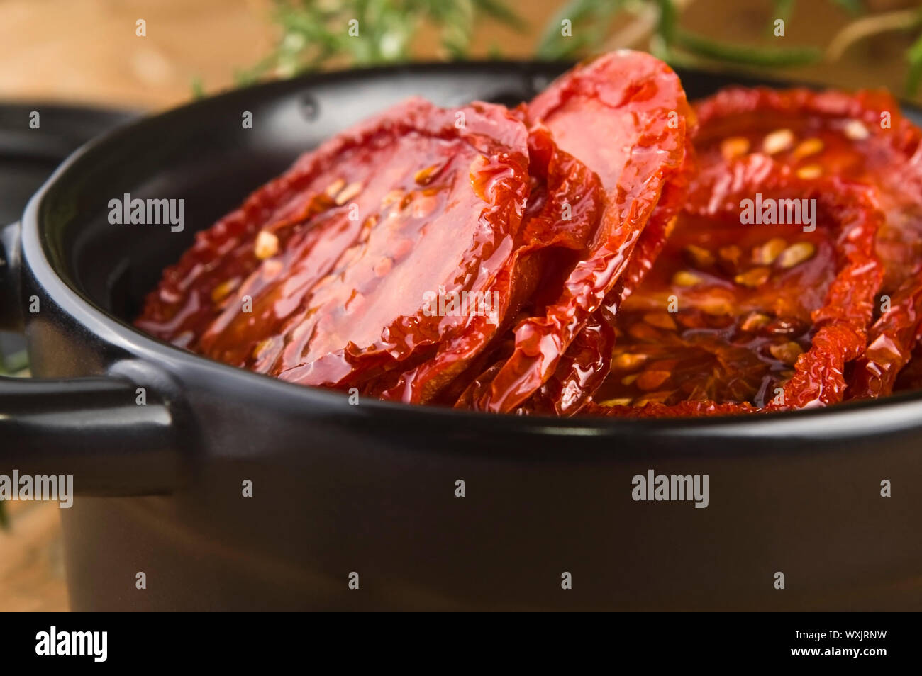 Sun dried tomatoes with olive oil Stock Photo - Alamy