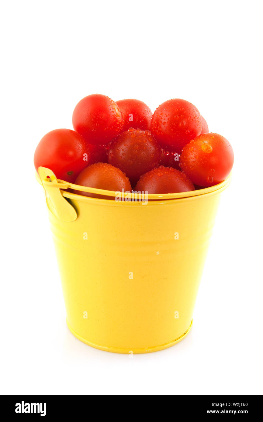 Yellow bucket full with fresh cherry tomatoes Stock Photo