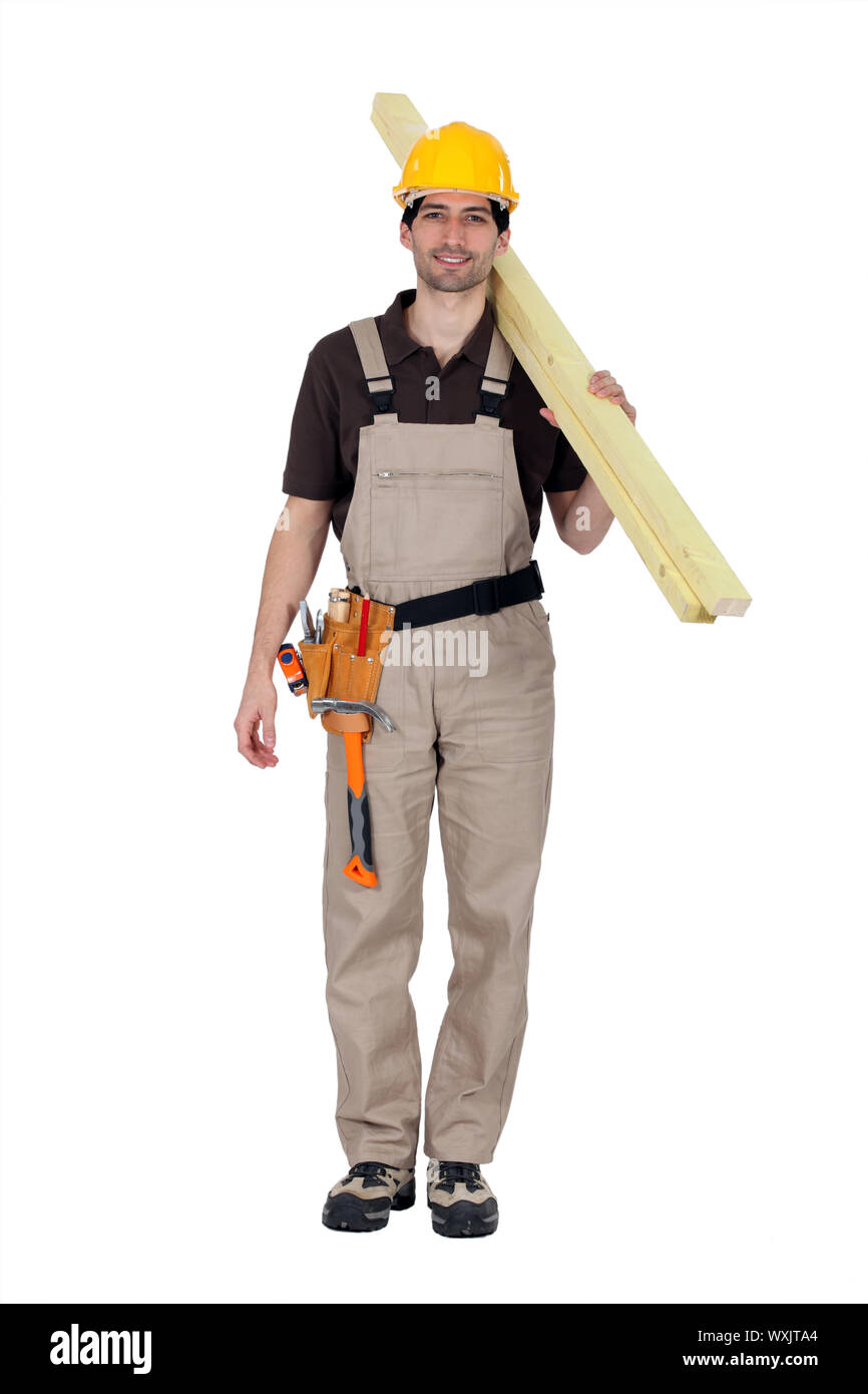 A builder carrying wooden planks Stock Photo