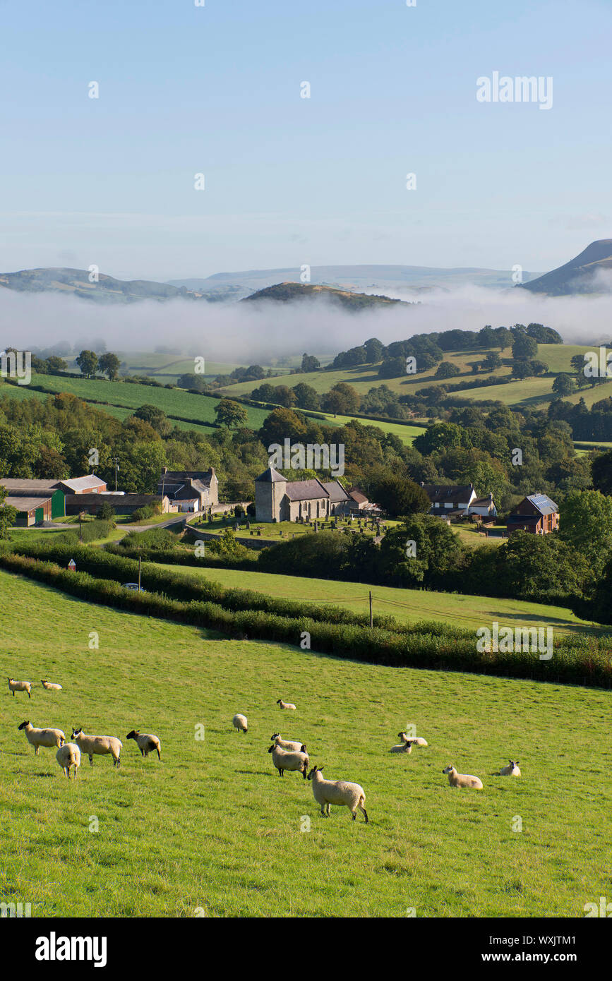 Llanddewi'r Cwm, Powys, UK. 17th September 2019. Mist hangs in the valleys surrounding St. David's church in the small Welsh village of Llanddewi'r Cwm in Powys, UK. after a cold night with temperatures dropping to aroun 7 deg C. © Graham M. Lawrence/Alamy Live News. Stock Photo