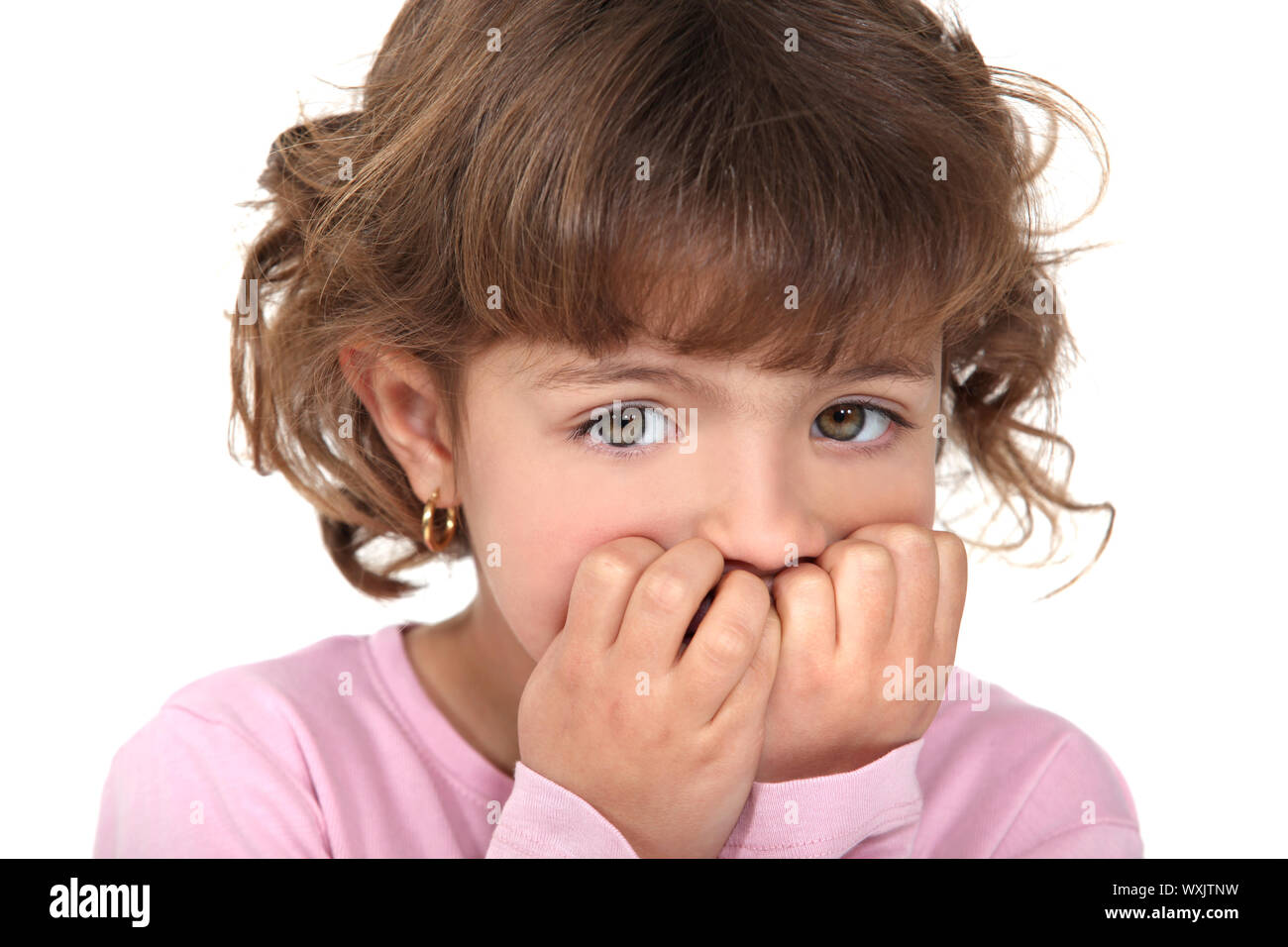 Scared little girl biting nails Stock Photo - Alamy