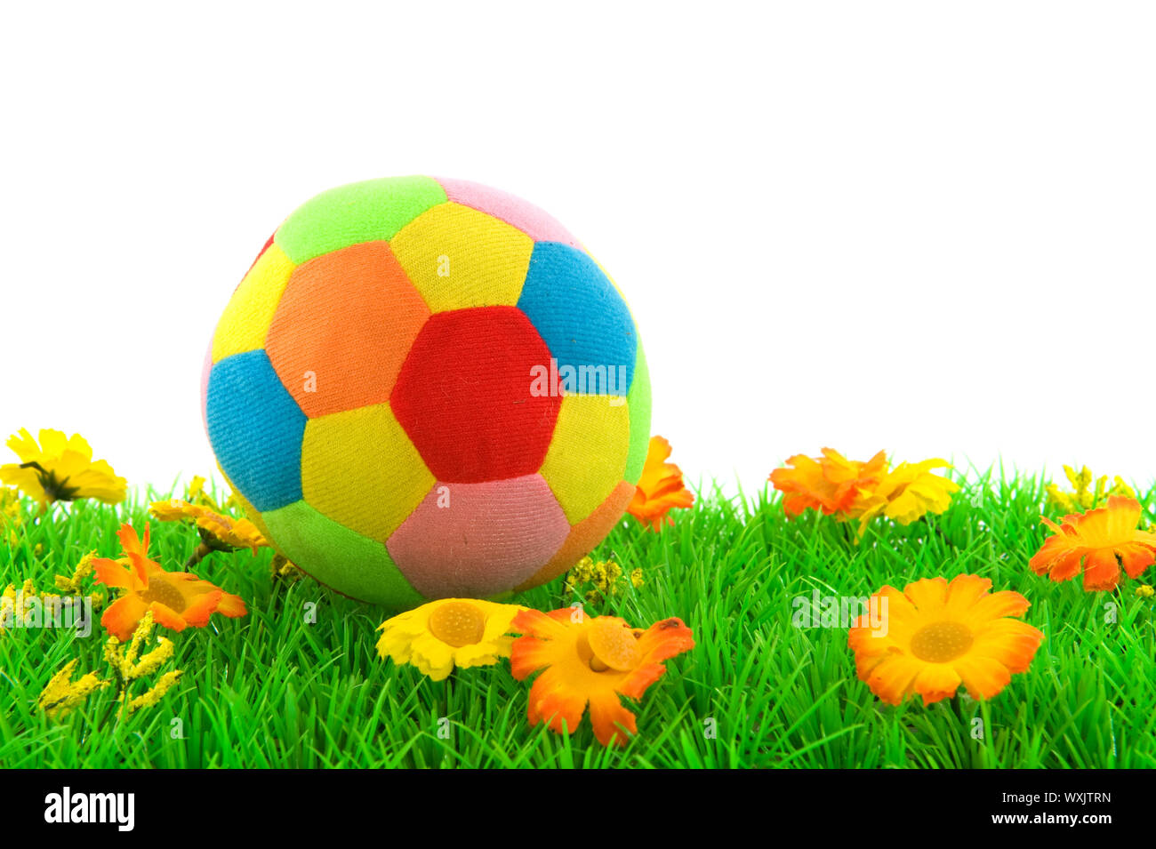 Green grass with toy ball and white background Stock Photo - Alamy