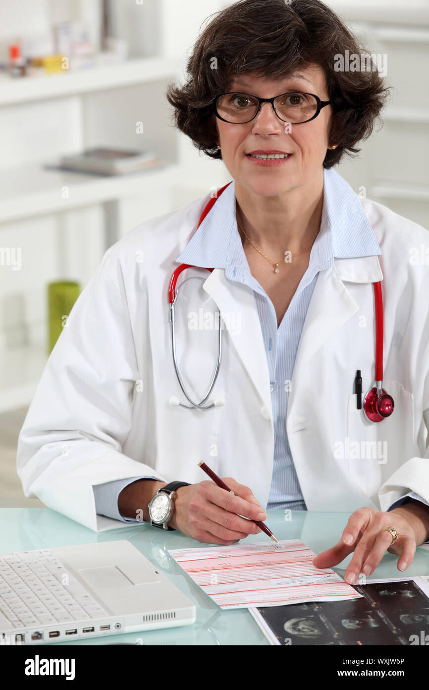 Female doctor writing prescription Stock Photo - Alamy
