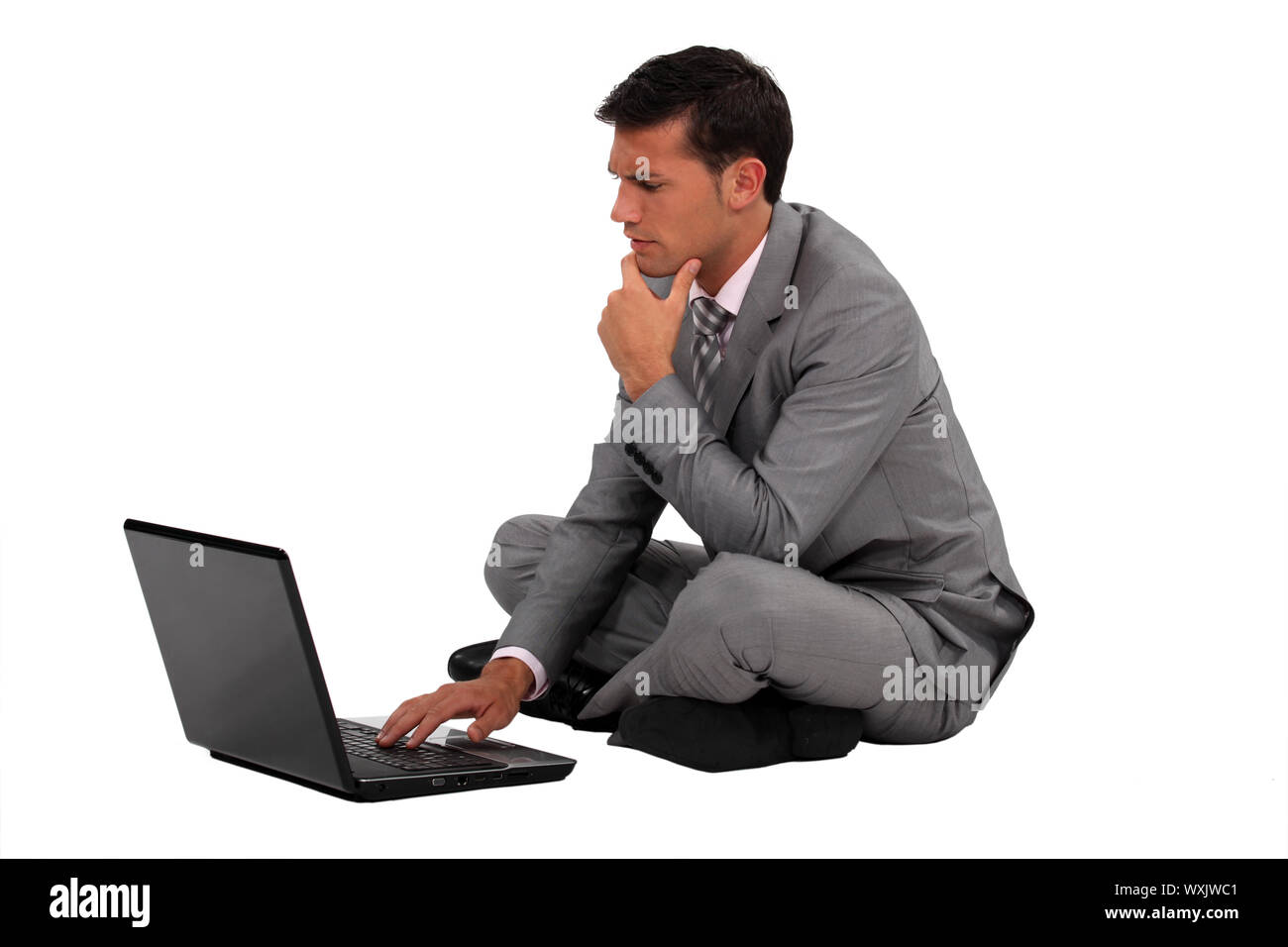 Businessman sat cross legged on the floor Stock Photo - Alamy