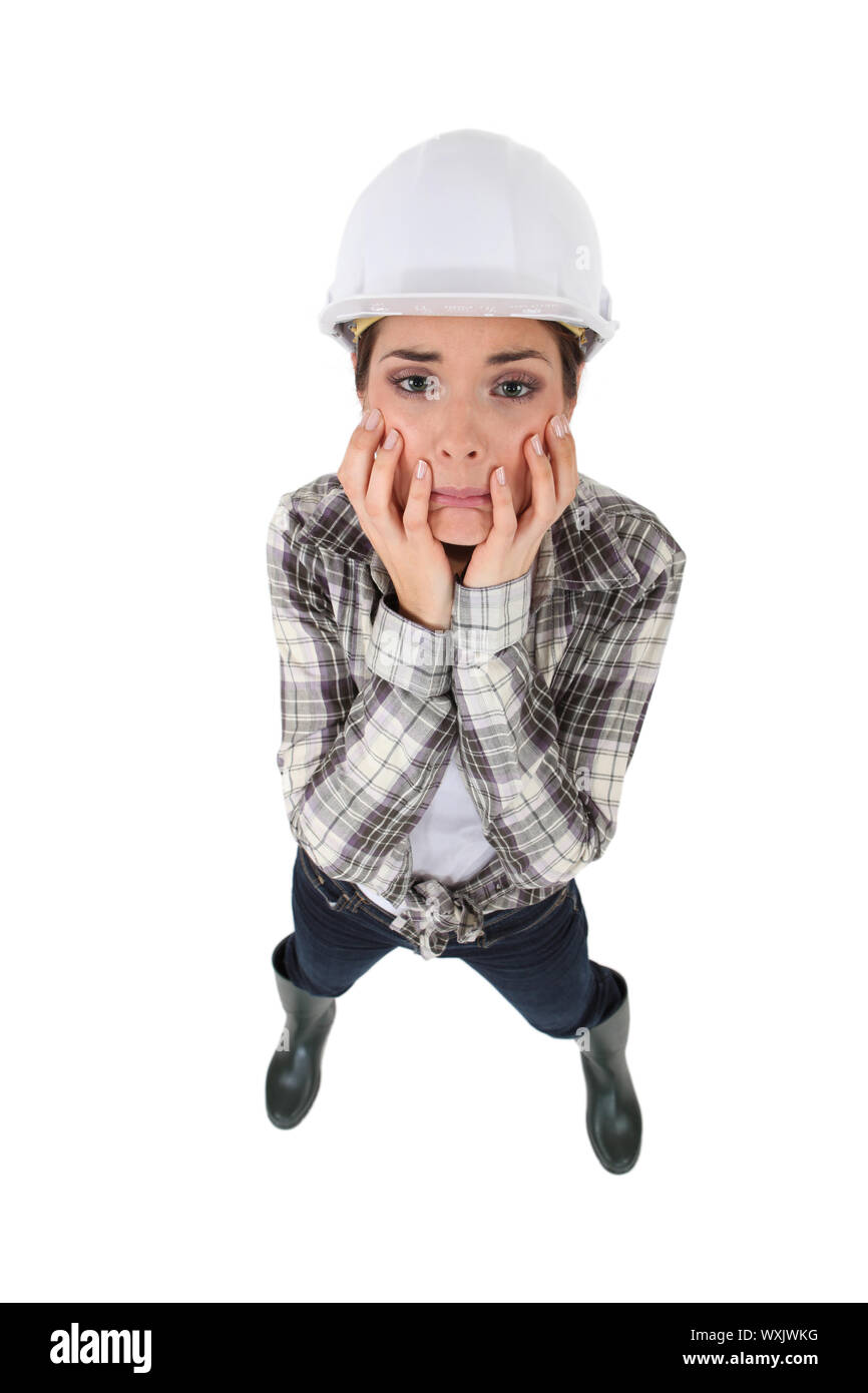 Distraught female construction worker Stock Photo