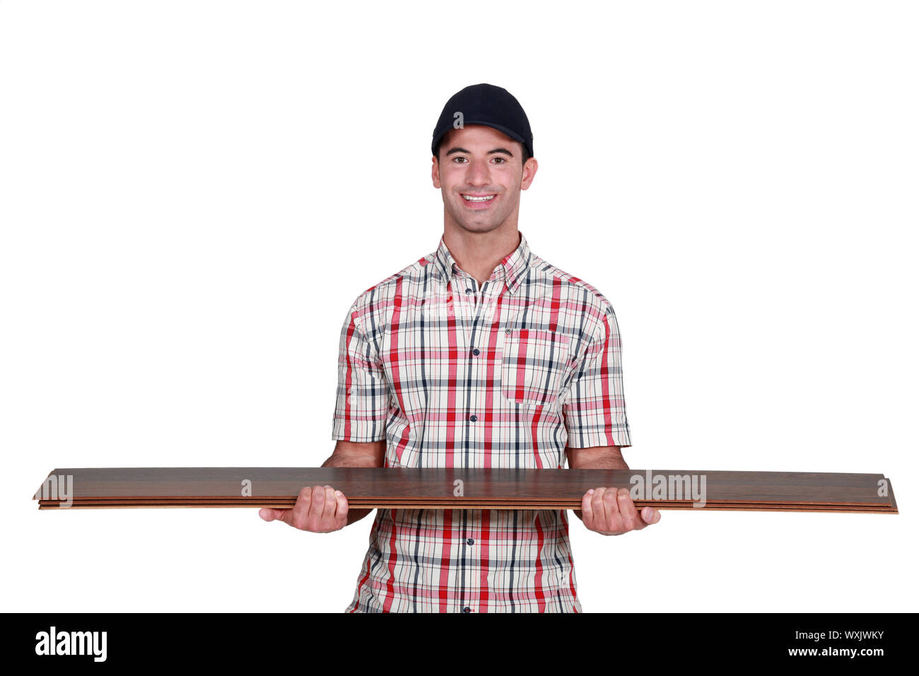 Worker carrying plywood Stock Photo