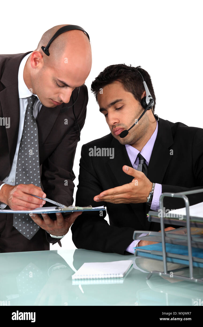 Telephone operators discussing the timetable Stock Photo - Alamy