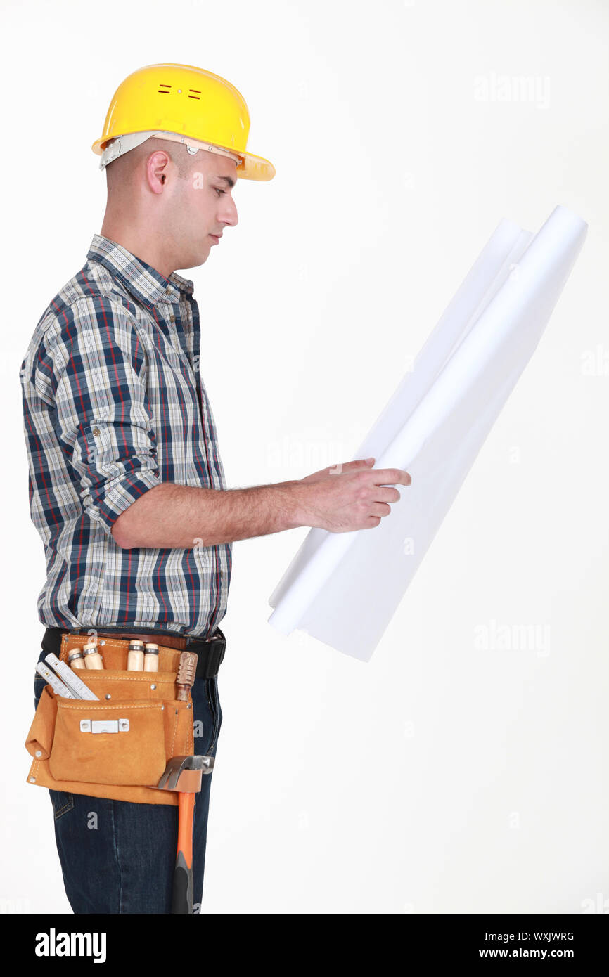 craftsman looking at a blueprint Stock Photo - Alamy