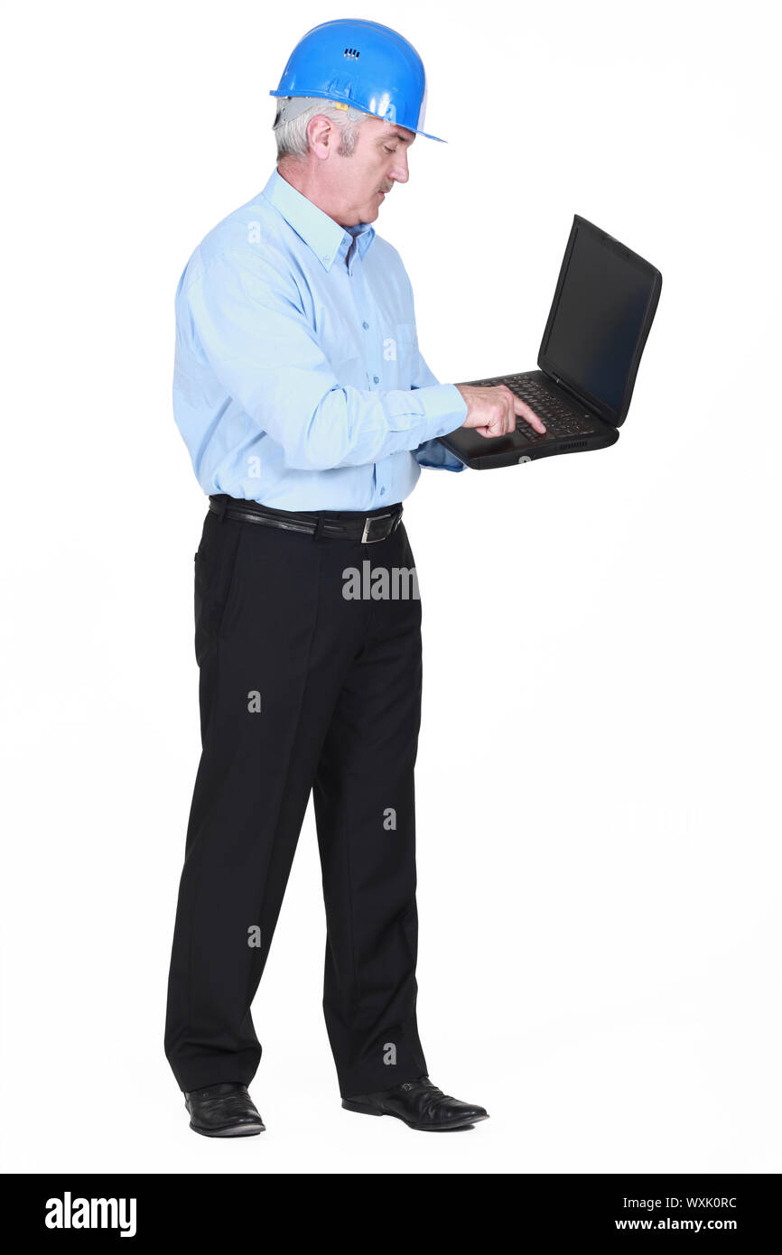 Senior architect typing on laptop Stock Photo