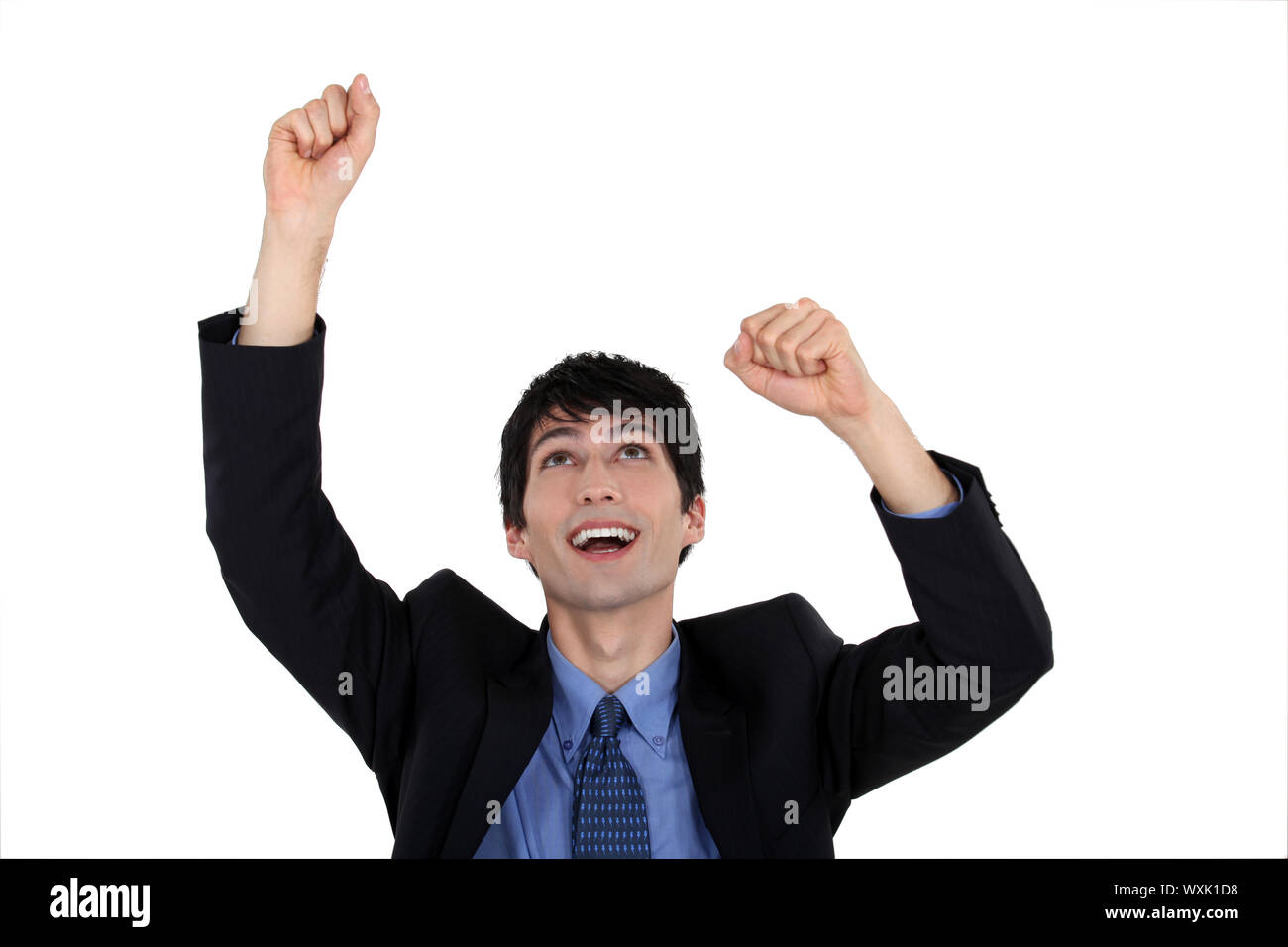 Excited businessman raising his arms in the air Stock Photo - Alamy