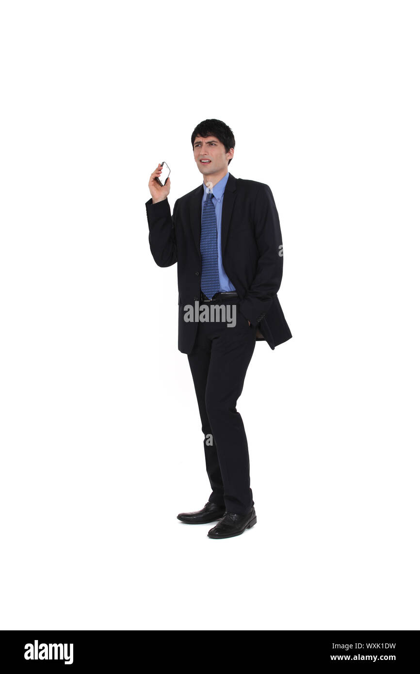 Businessman holding his mobile phone Stock Photo