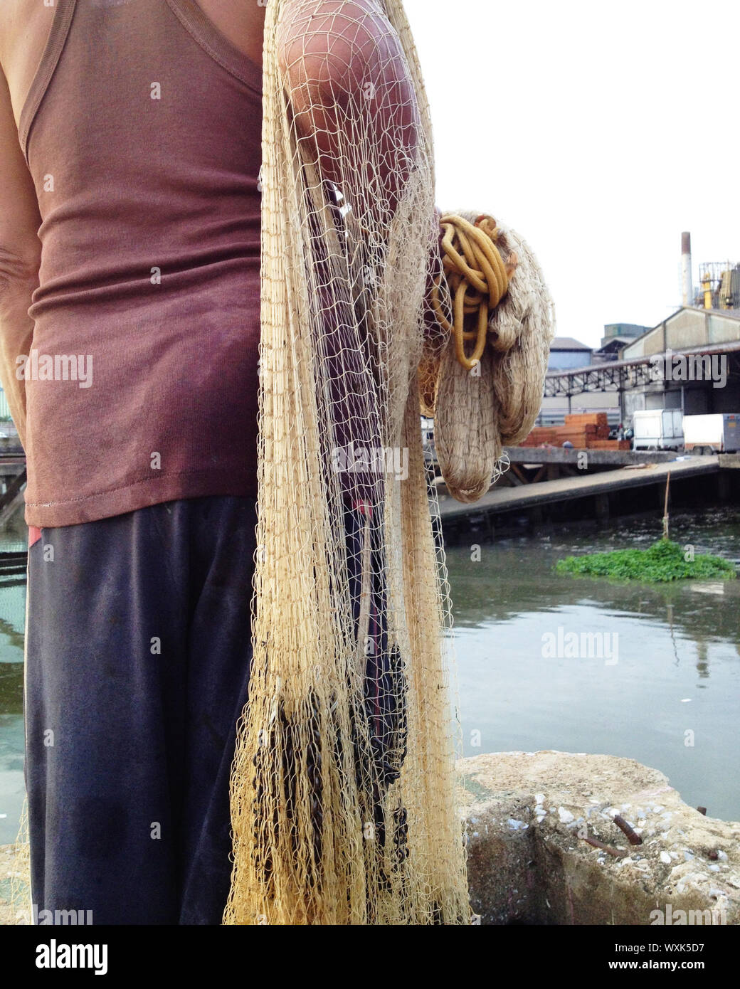 Fisherman pulling in his Fishing Net Stock Photo