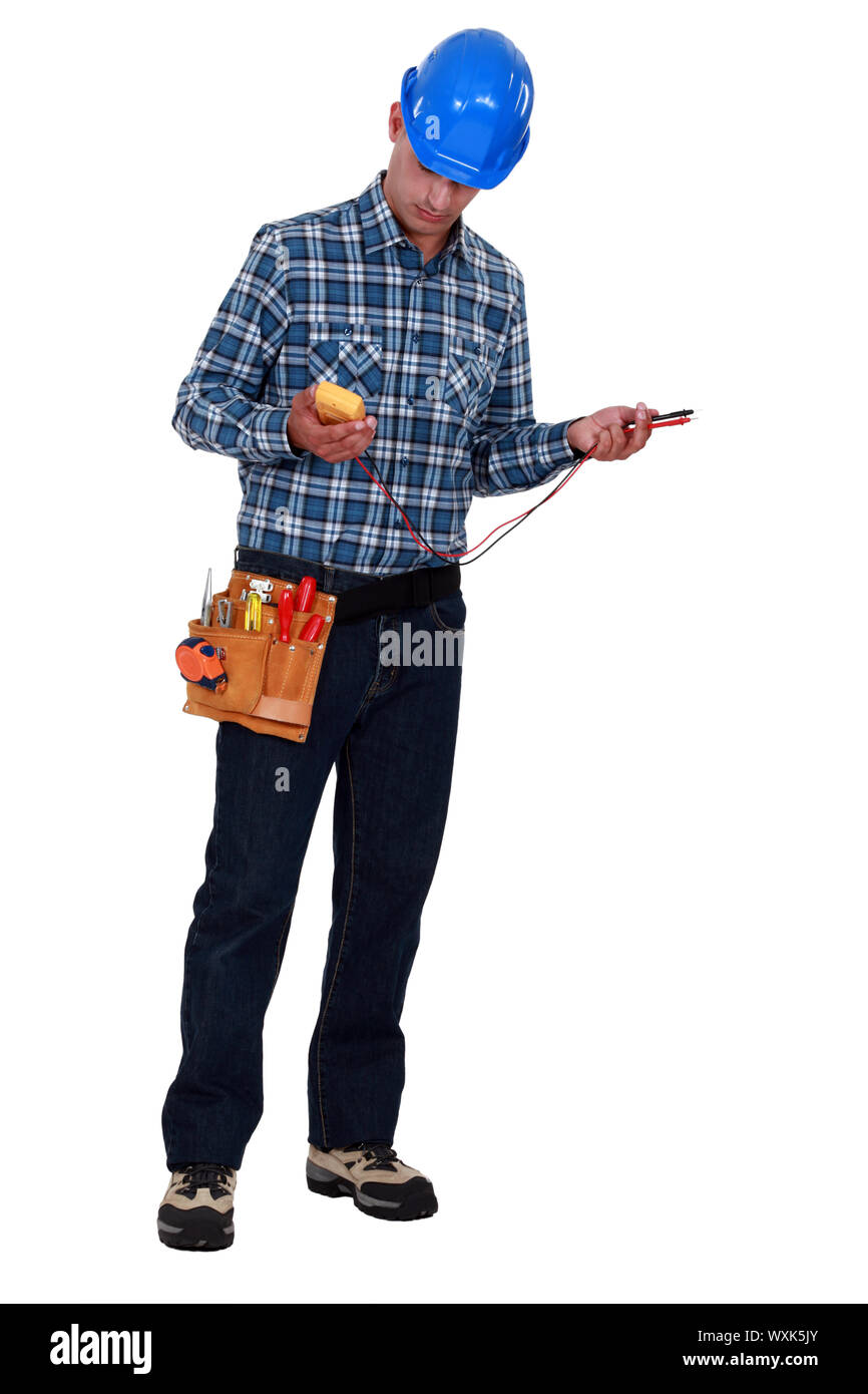 A male electrician checking a voltmeter. Stock Photo