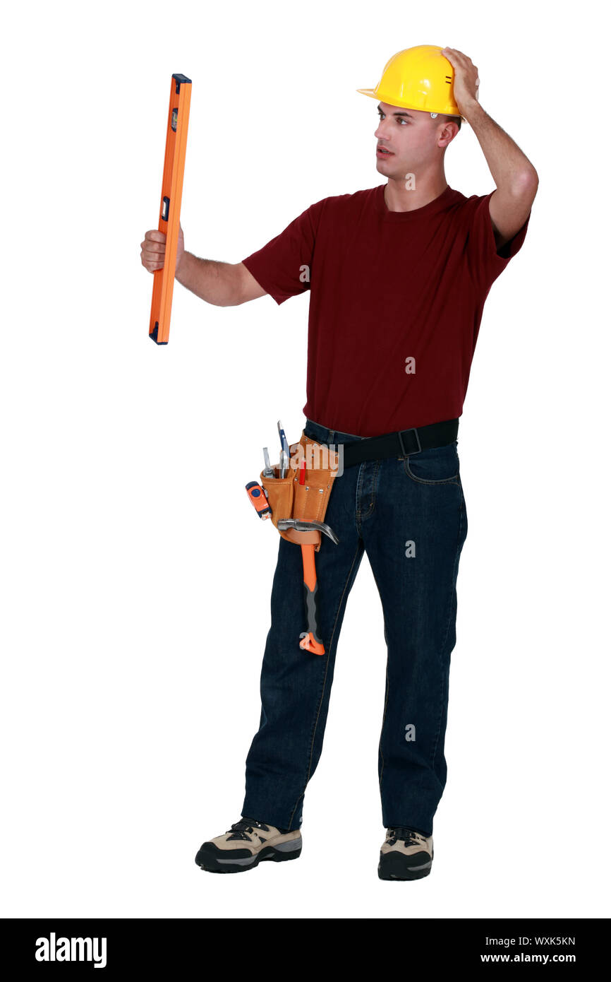 Mason holding spirit level Stock Photo